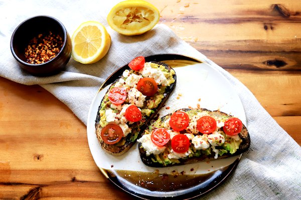Image of Smash avocado in a bowl and spread among toasted bread...