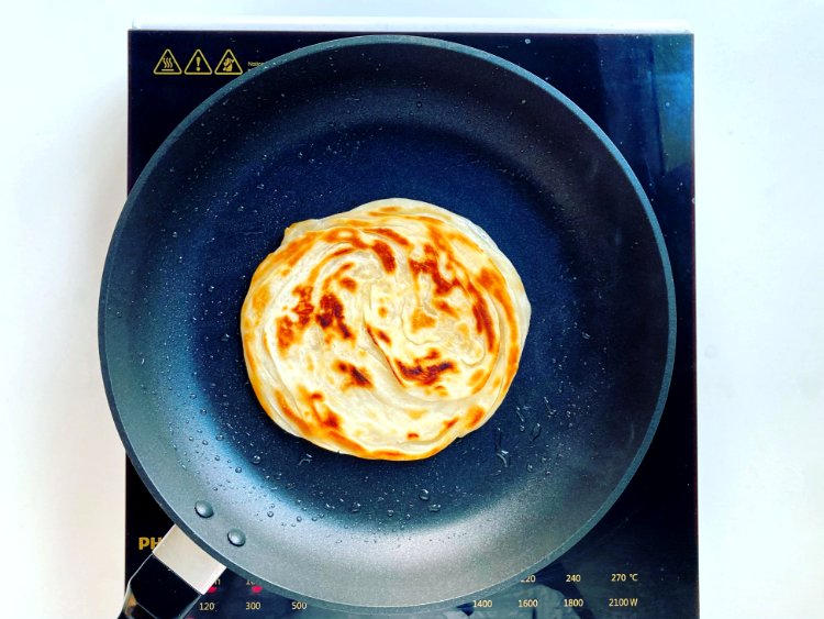Image of Grill ParanthasIn a flat non-stick pan, add half of the...